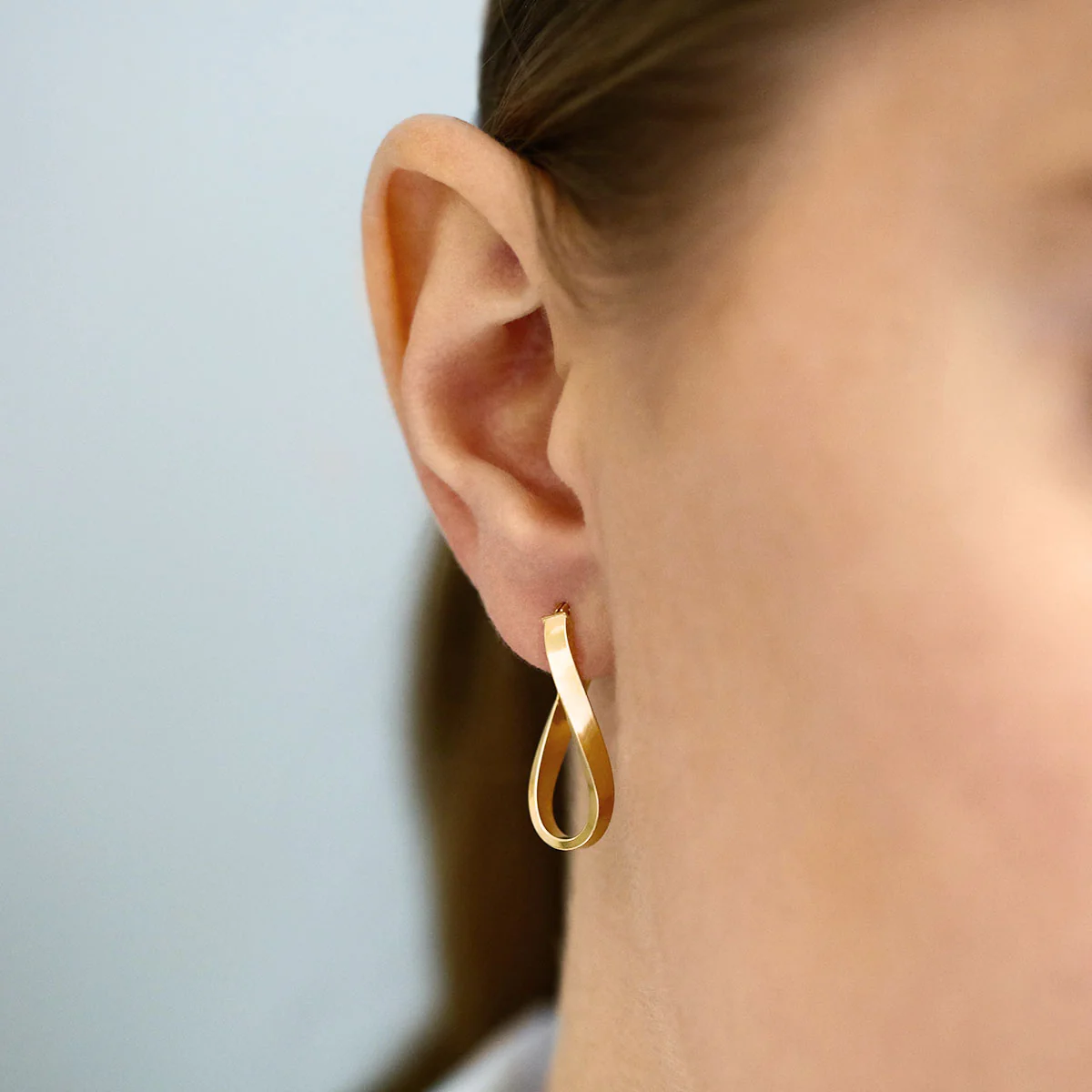 Soleil Collection 10.5mm x 26.5mm Twisted Oval Hoop Creole Earrings | 9K Yellow Gold - Image 5