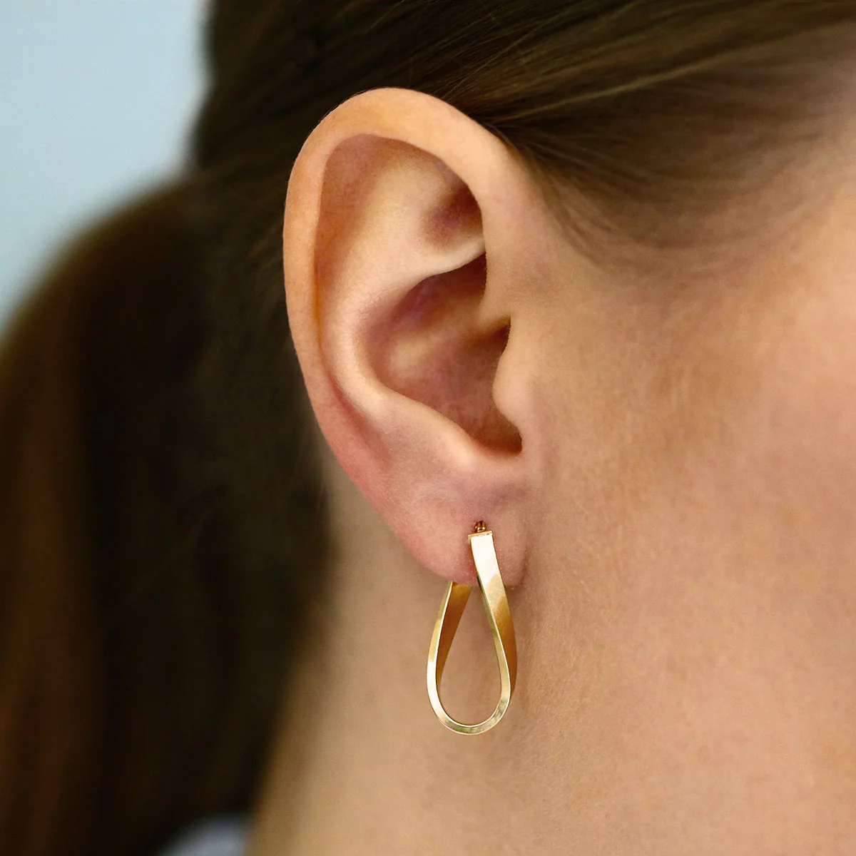 Soleil Collection 10.5mm x 26.5mm Twisted Oval Hoop Creole Earrings | 9K Yellow Gold - Image 6