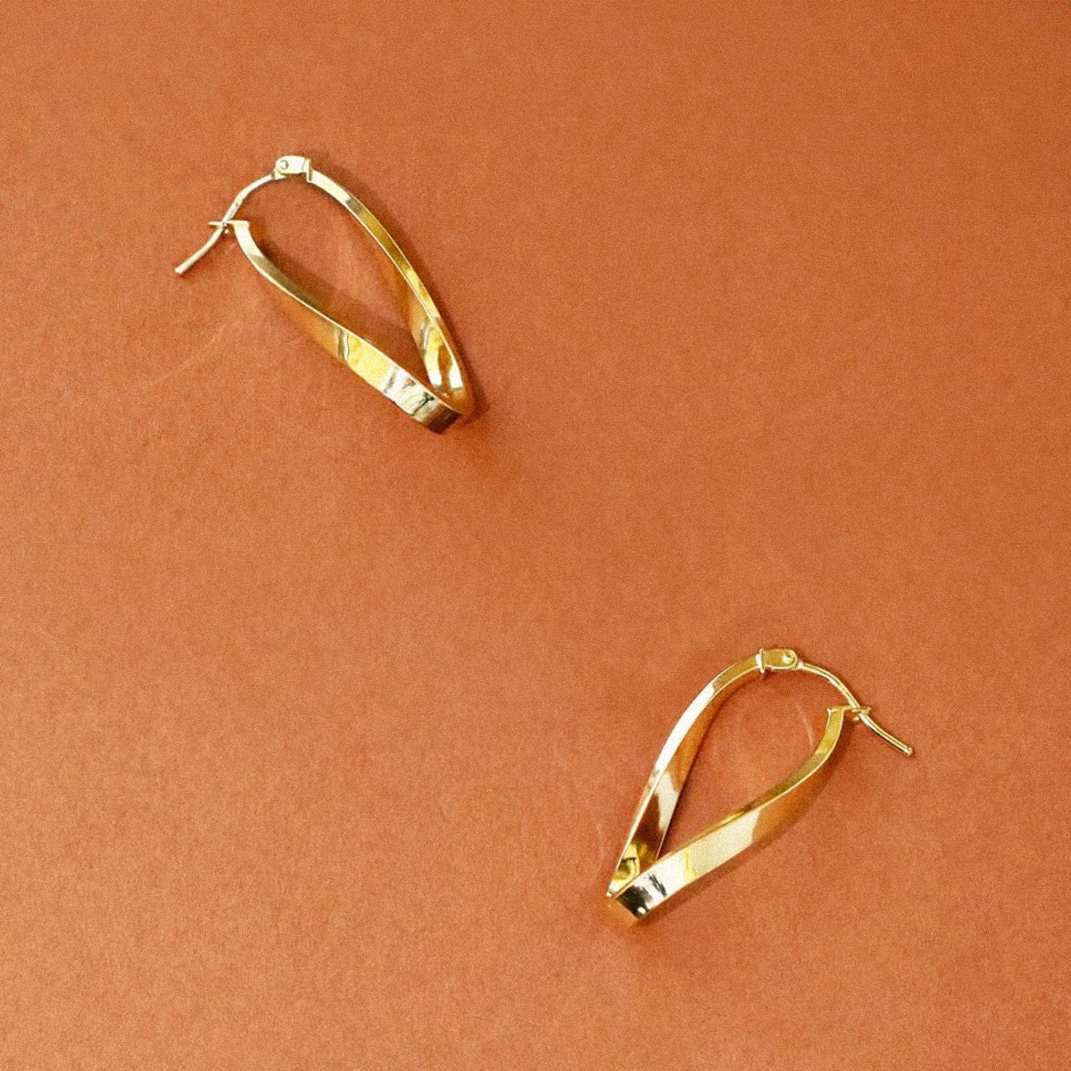Soleil Collection 10.5mm x 26.5mm Twisted Oval Hoop Creole Earrings | 9K Yellow Gold - Image 7